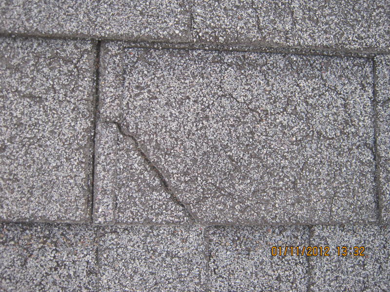 Close-up of roof shingle damage and deterioration captured by drone